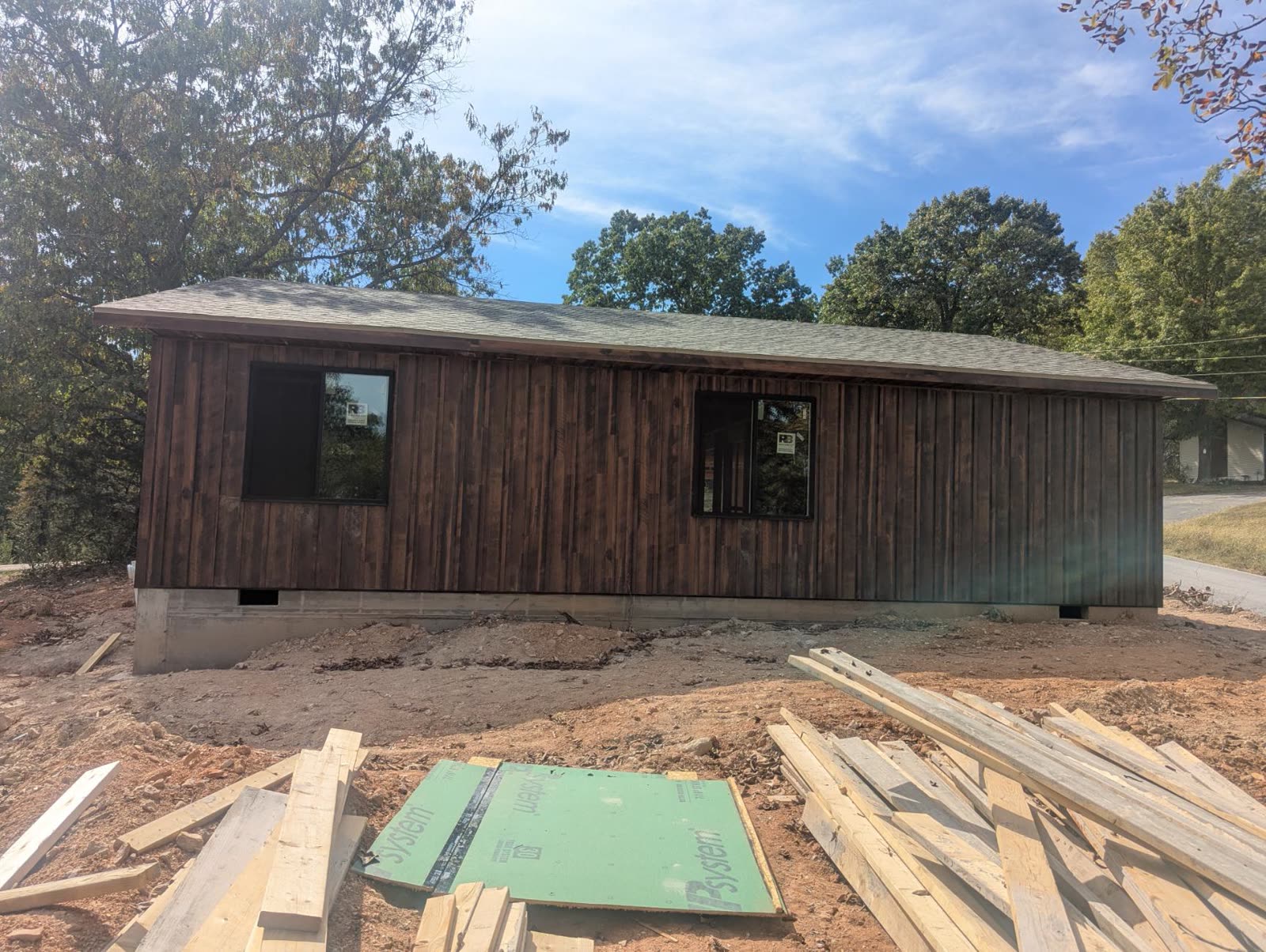 Side wall with wood siding and two windows set